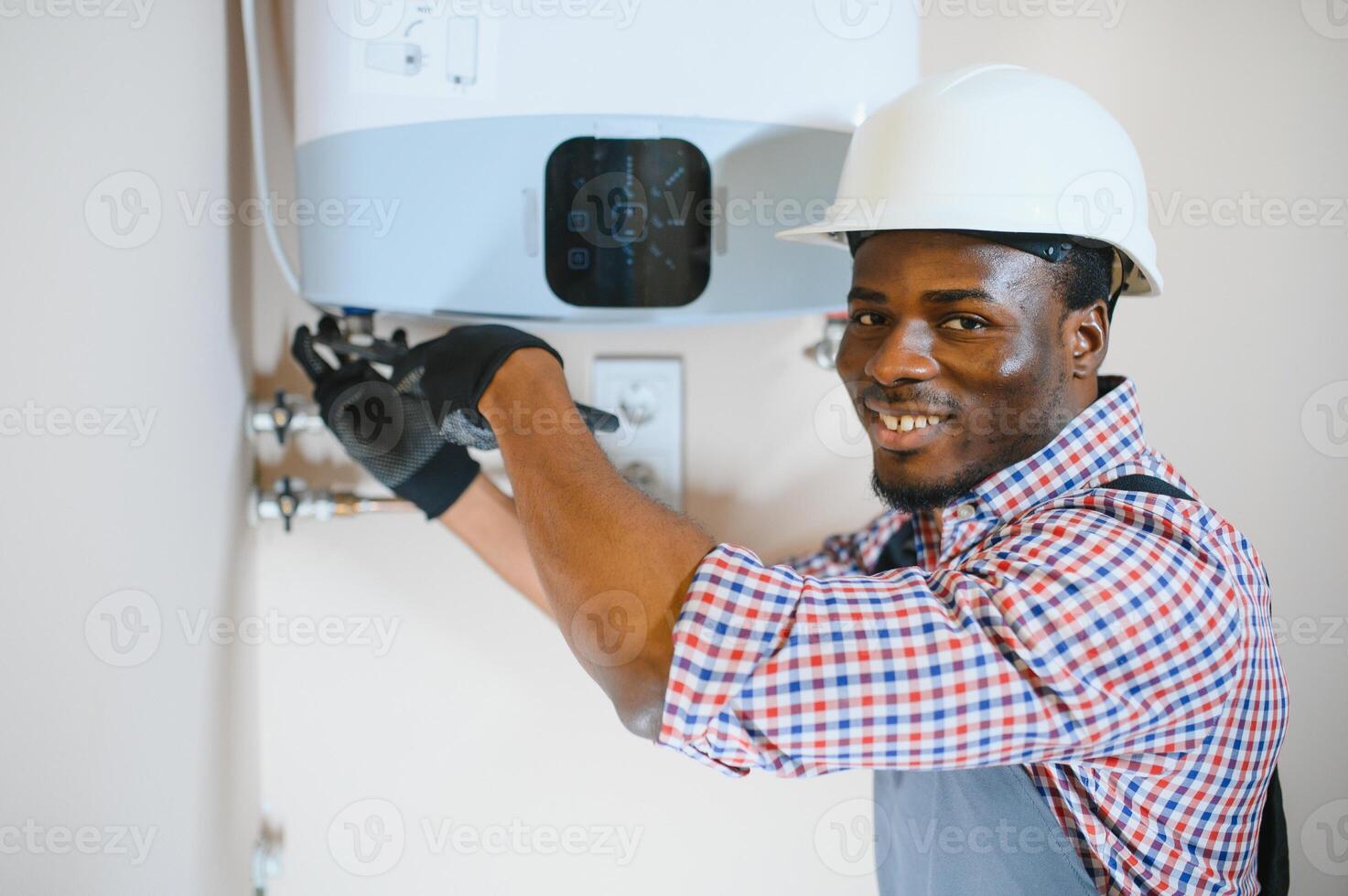 Professional engineer installing a natural gas boiler at home, he is checking the pipes photo