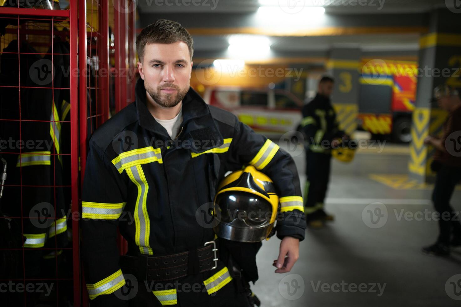 A firefighter puts on a fire uniform at the fire department photo