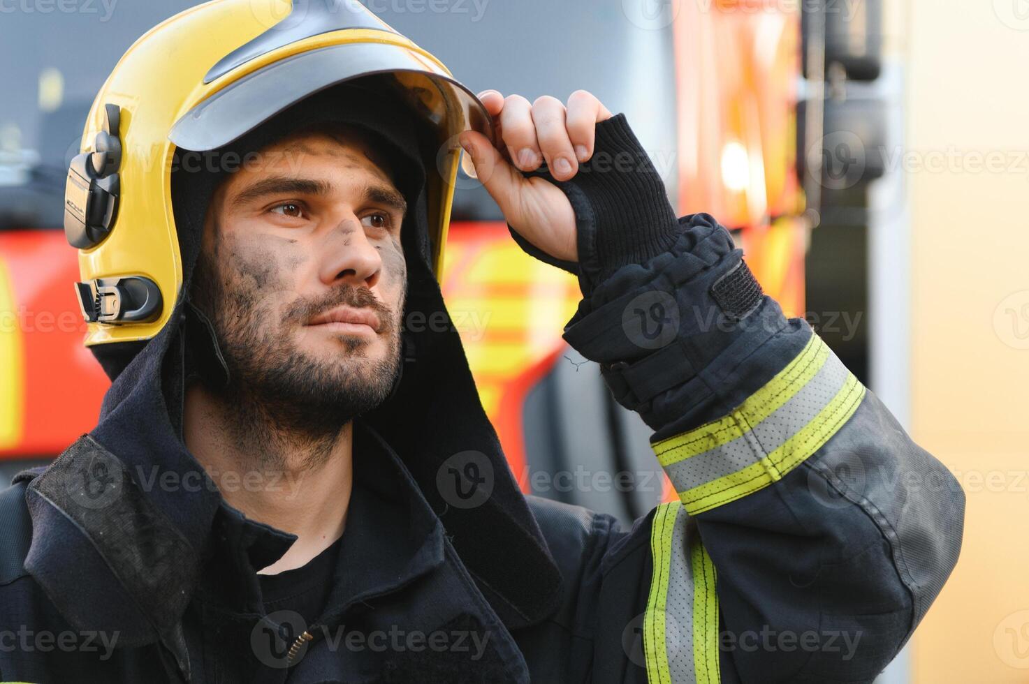 Firefighter rests after fighting a house fire photo