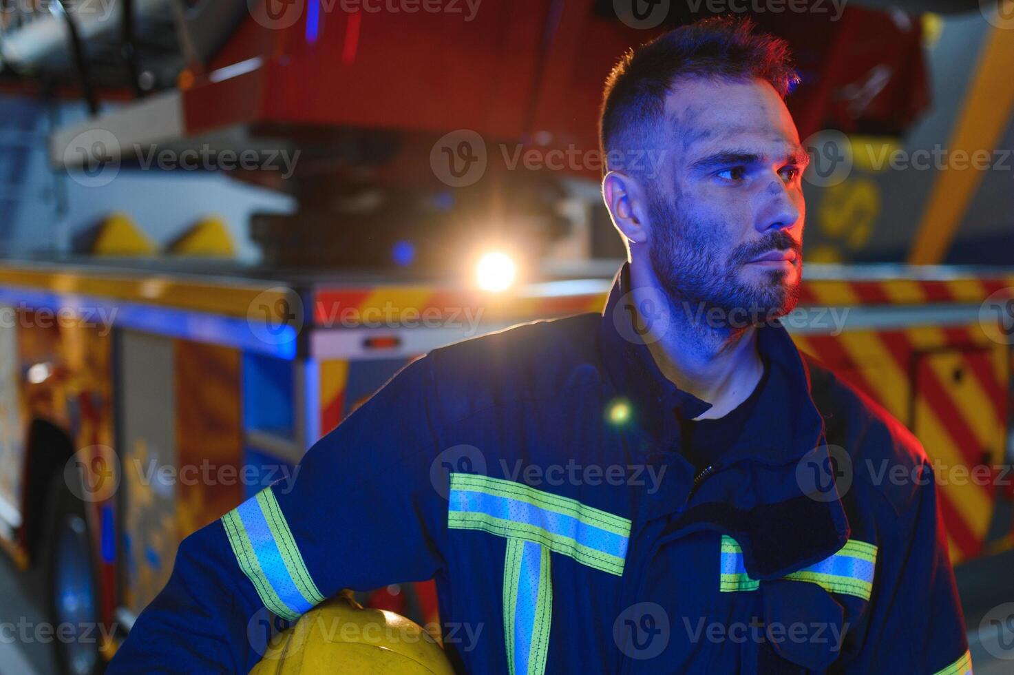 Photo of fireman with gas mask and helmet near fire engine