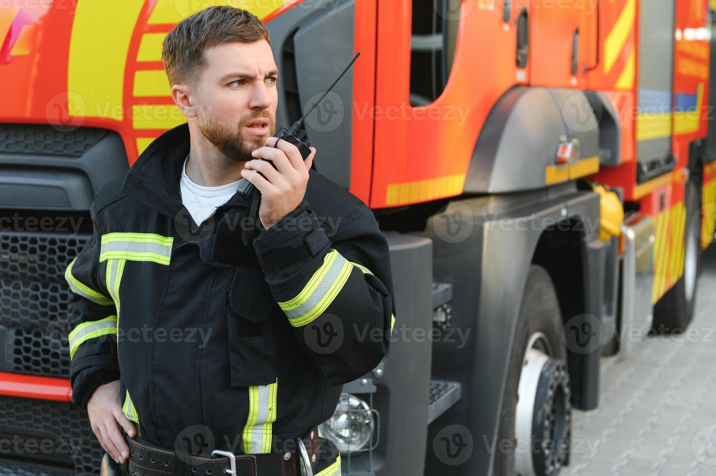 Photo of fireman with gas mask and helmet near fire engine