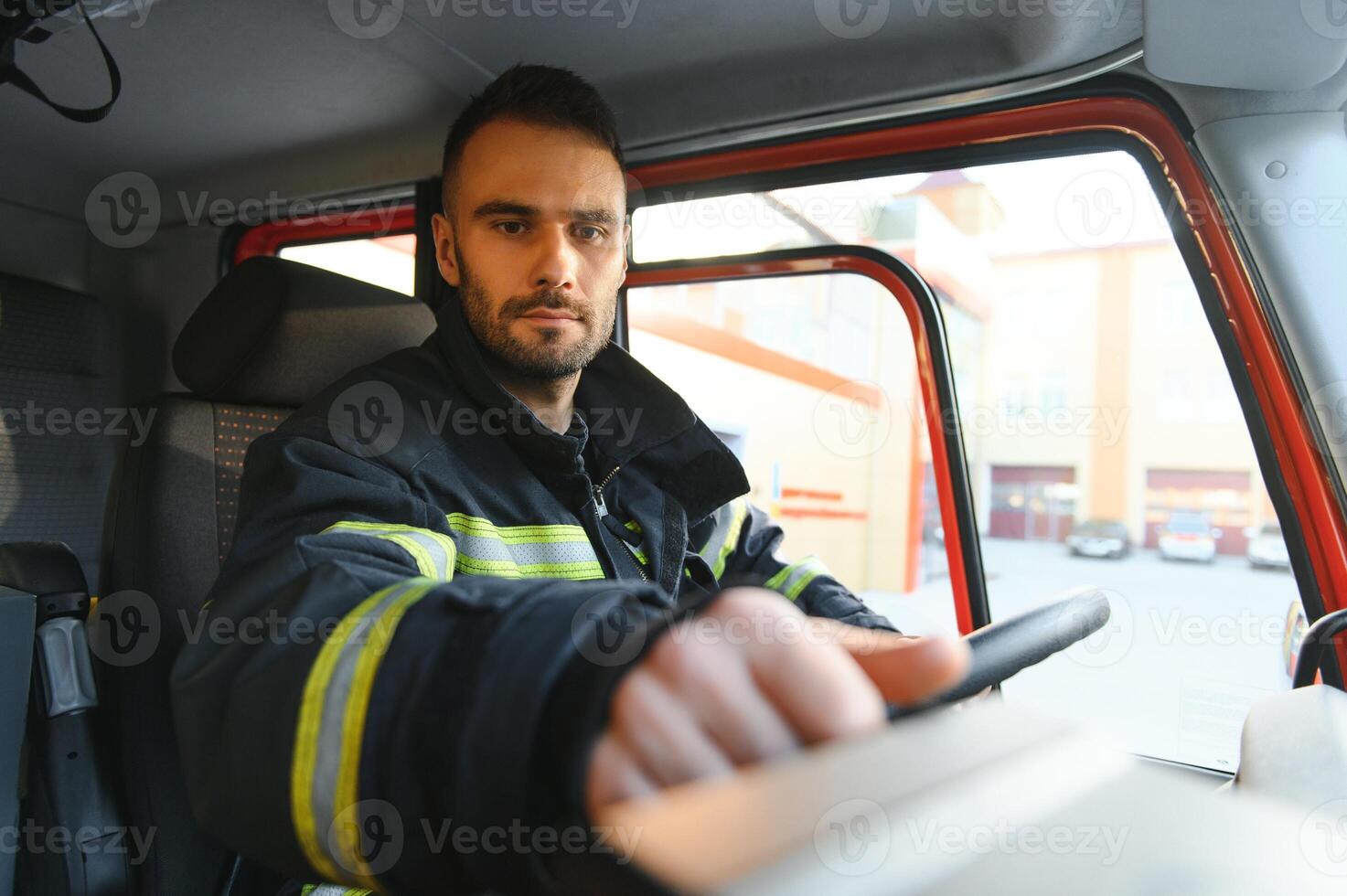 Firefighter drives a emergency vehicle with communication interior view photo