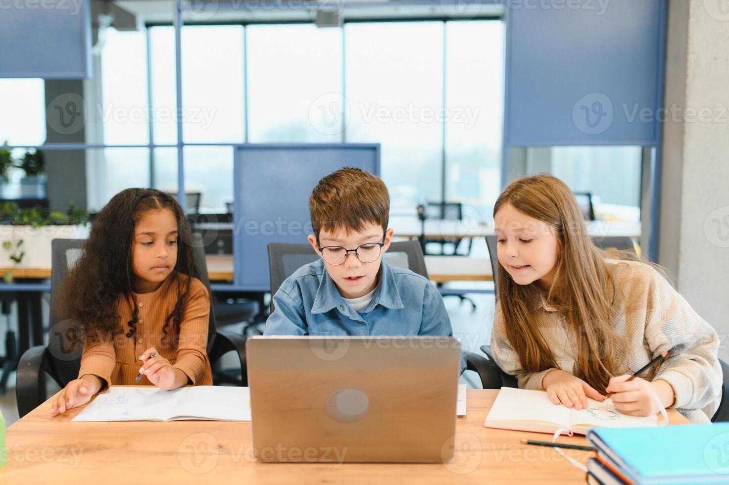 schoolchildren for a laptop at school photo