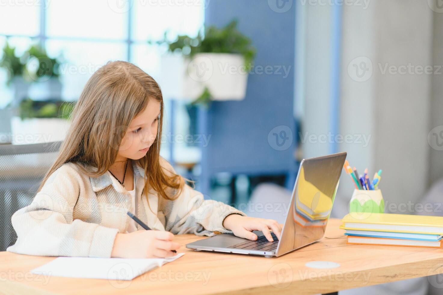 Smiling little Caucasian girl have call distant class with teacher photo