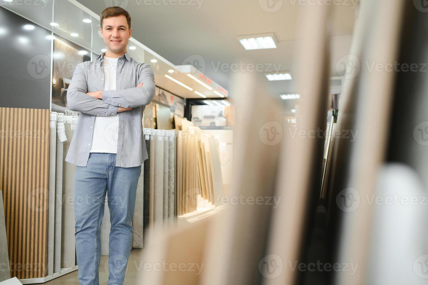 Male architect or interior designer choosing ceramic texture sample from swatch board in design studio photo