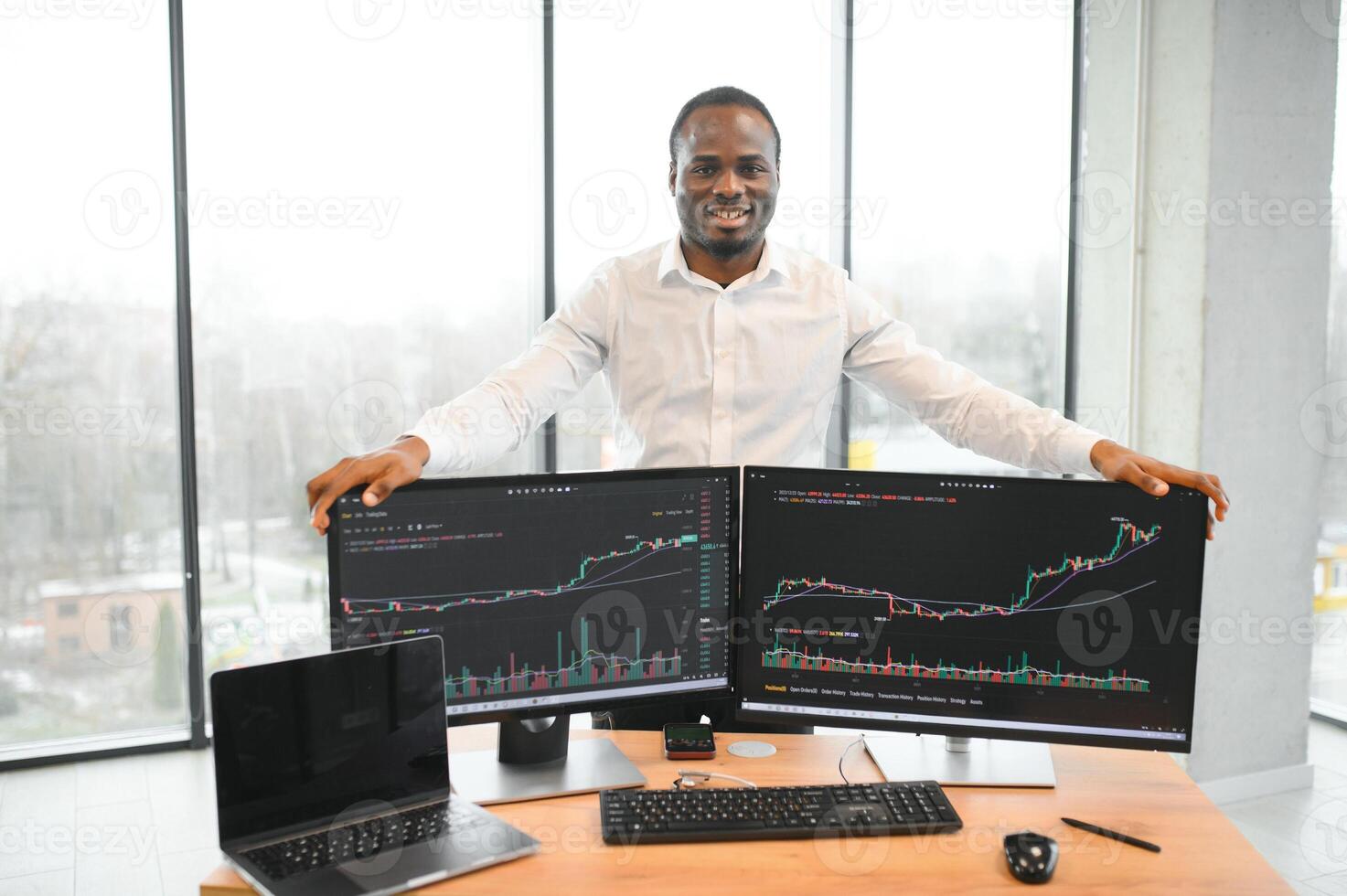 Stock Market Day Trader Working on Computer with Multi-Monitor Workstation with Real-Time Investmentment Charts photo