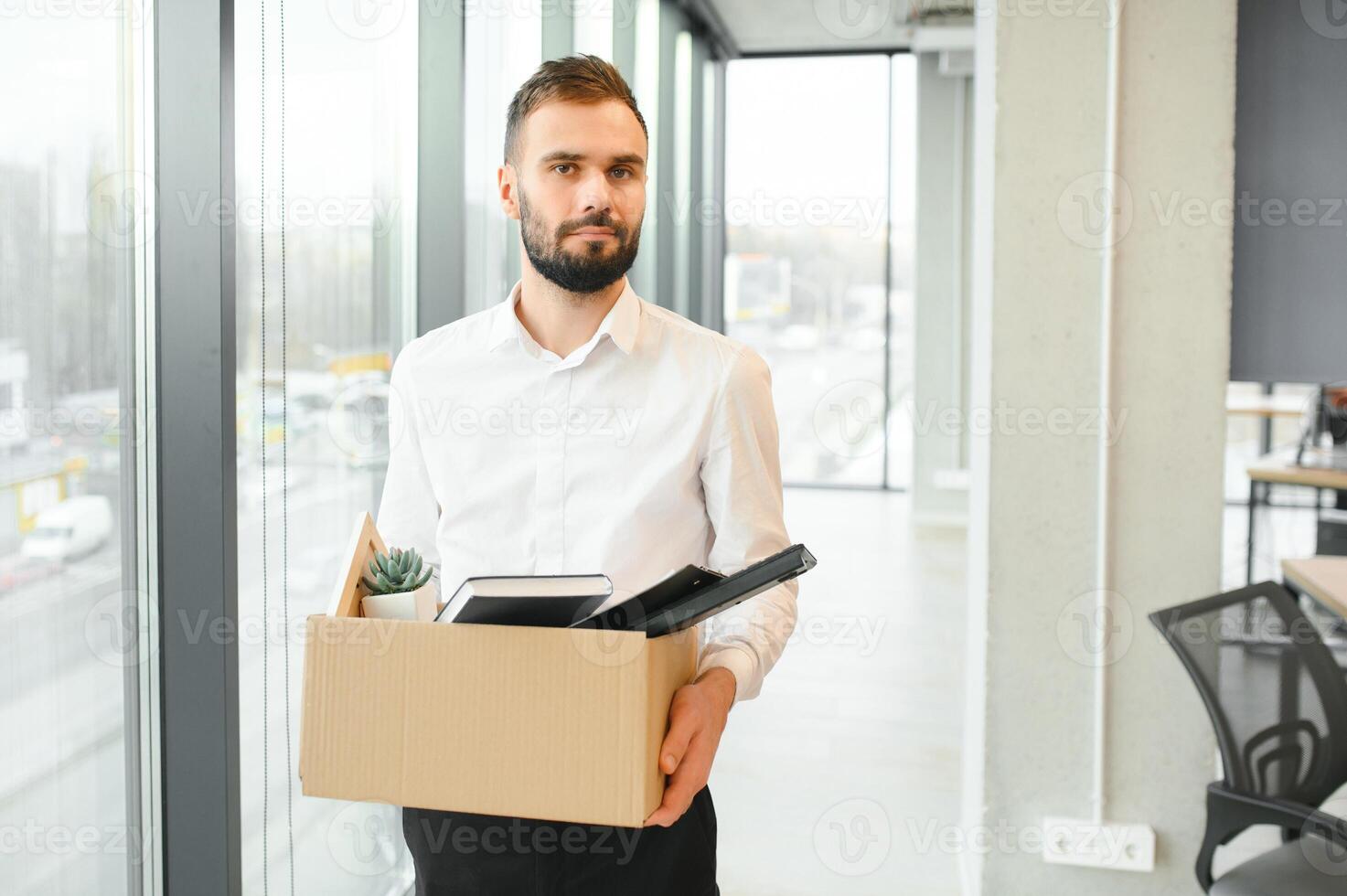 Man by dismissal. Guy lost job. Fired manager in company. Dismissal box in hands of employee. photo