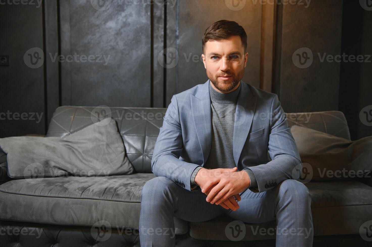 Respectable handsome man in elegant suit in apartments with classical luxurious interior. Men's beauty, fashion photo