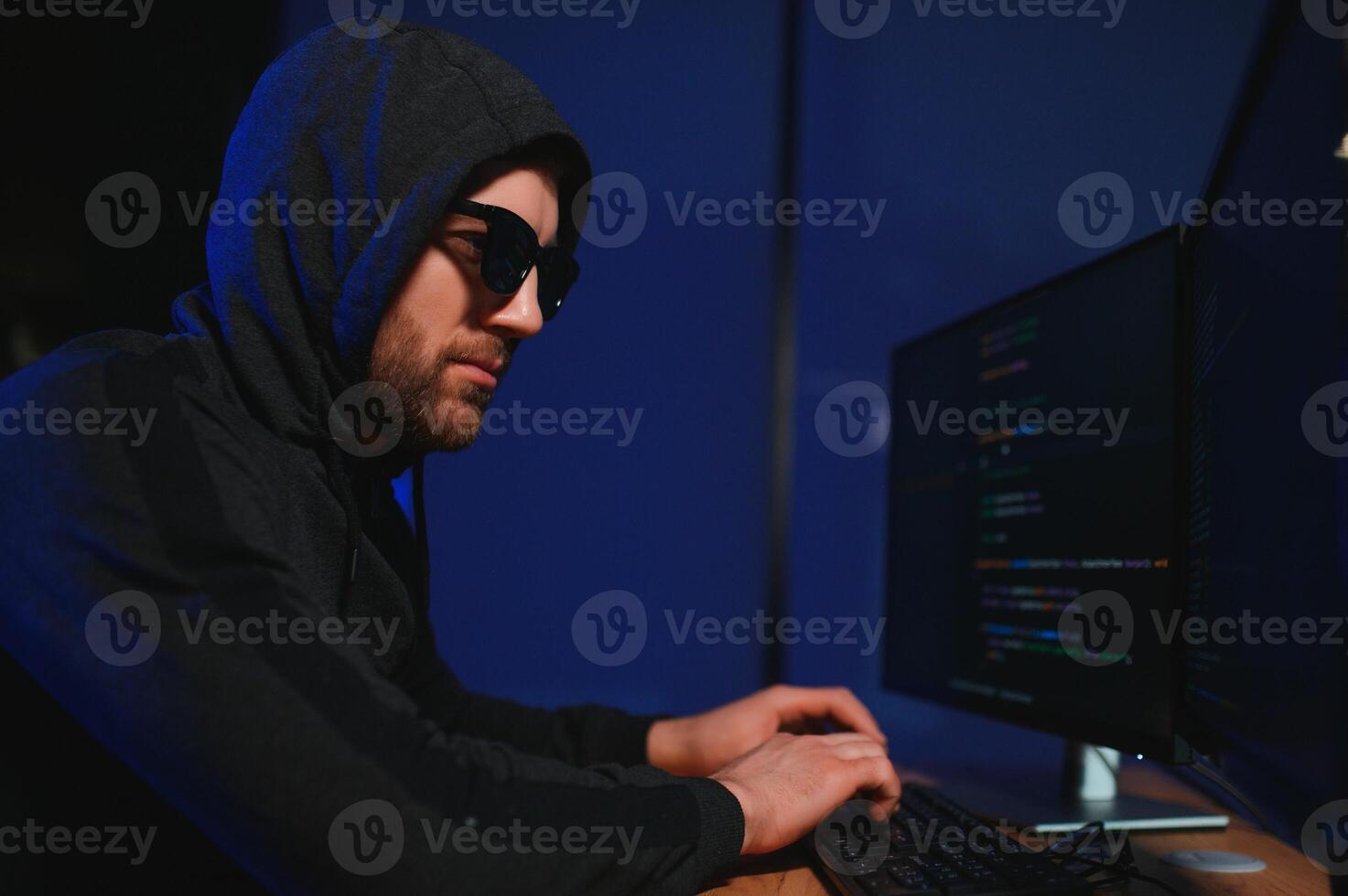 Programmer or computer hacker typing code photo
