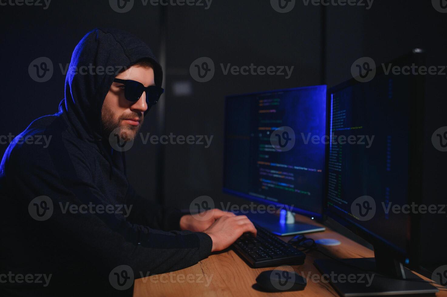Hacker is hacking into the computer network. Computer criminal photo