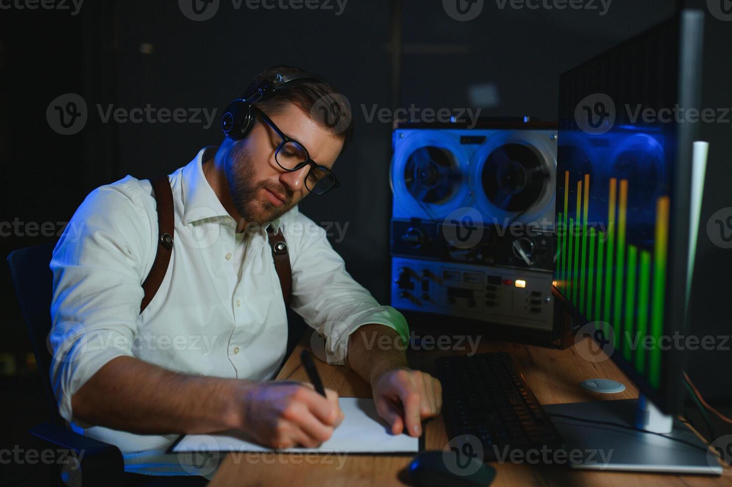Secret agent listens on the reel tape recorder. Officer wiretapping in headphones. Spying of conversations. Intelligence gathering. Espionage concept photo
