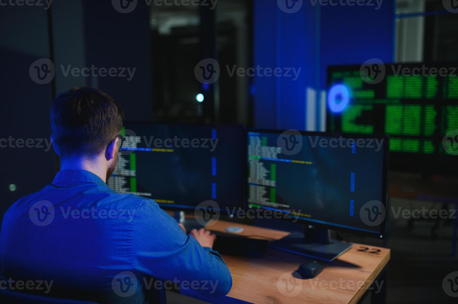 Night Office Young Handsome Man in Working on Desktop Computer. Digital Entrepreneur Typing Code photo