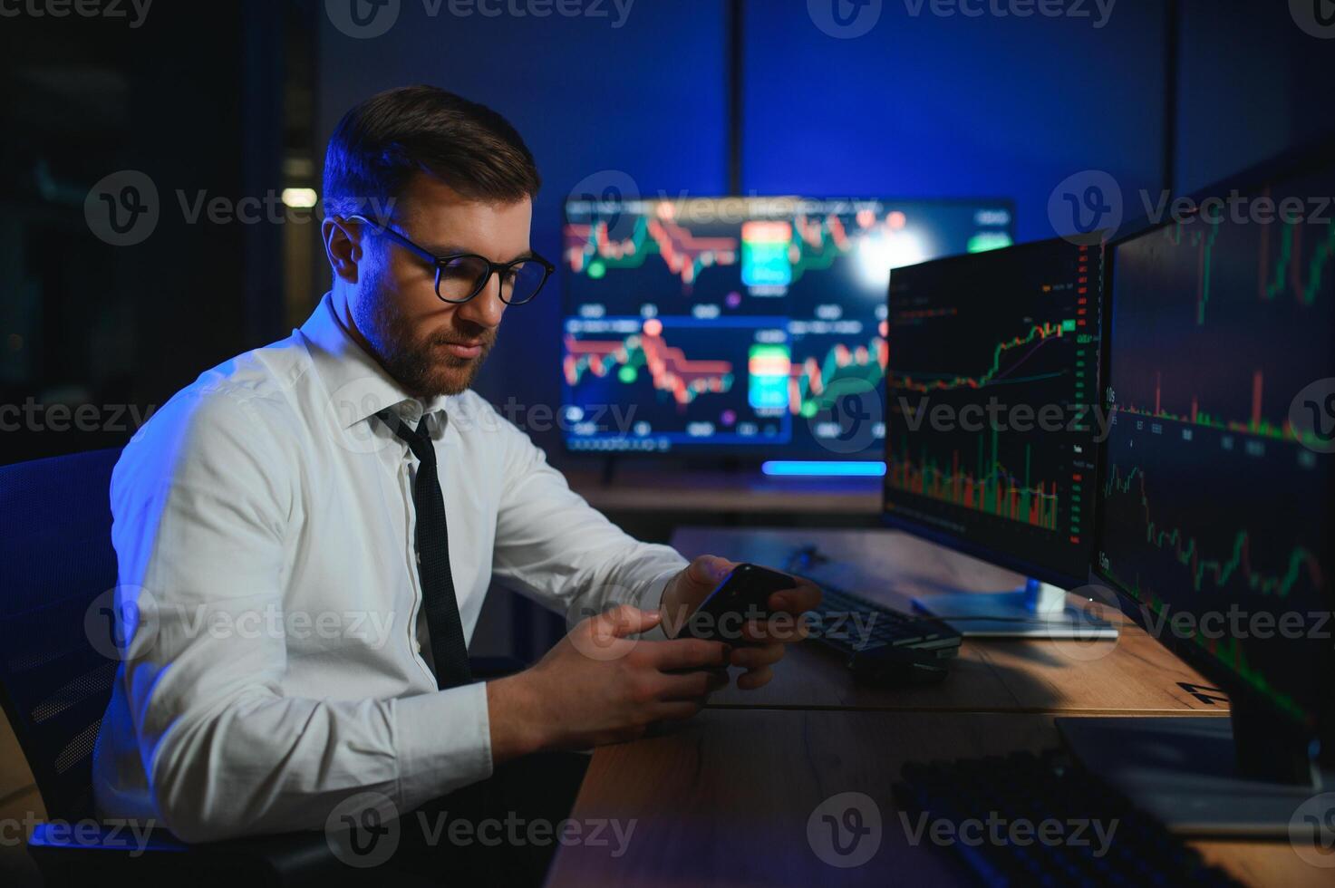 Financial Analysts and Day Traders Working on a Computers with Multi-Monitor photo
