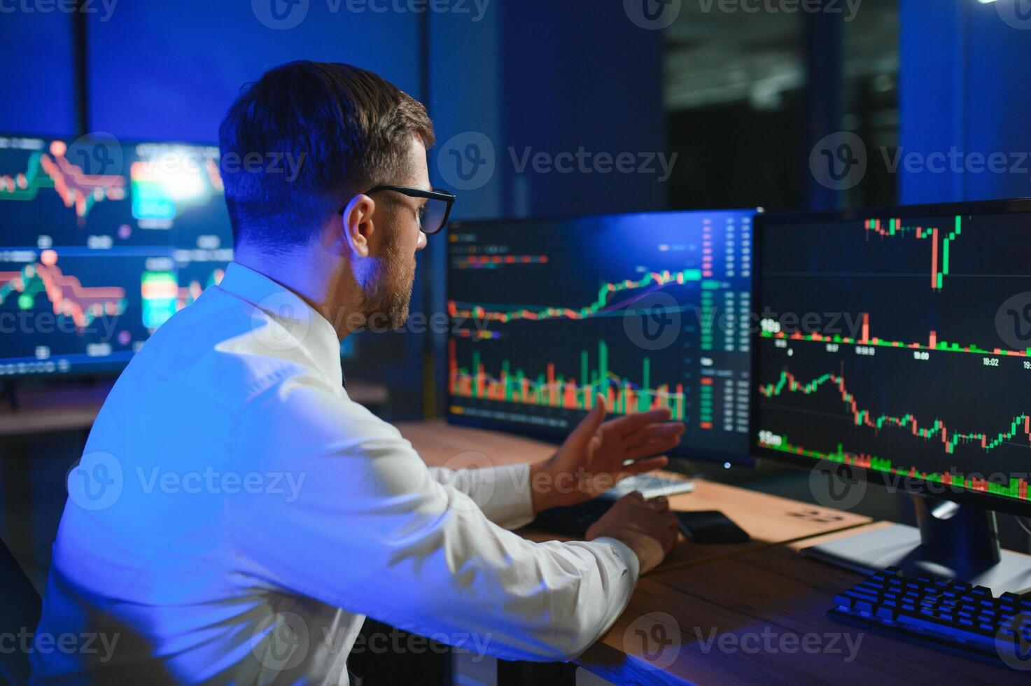 Financial Analysts and Day Traders Working on a Computers with Multi-Monitor photo