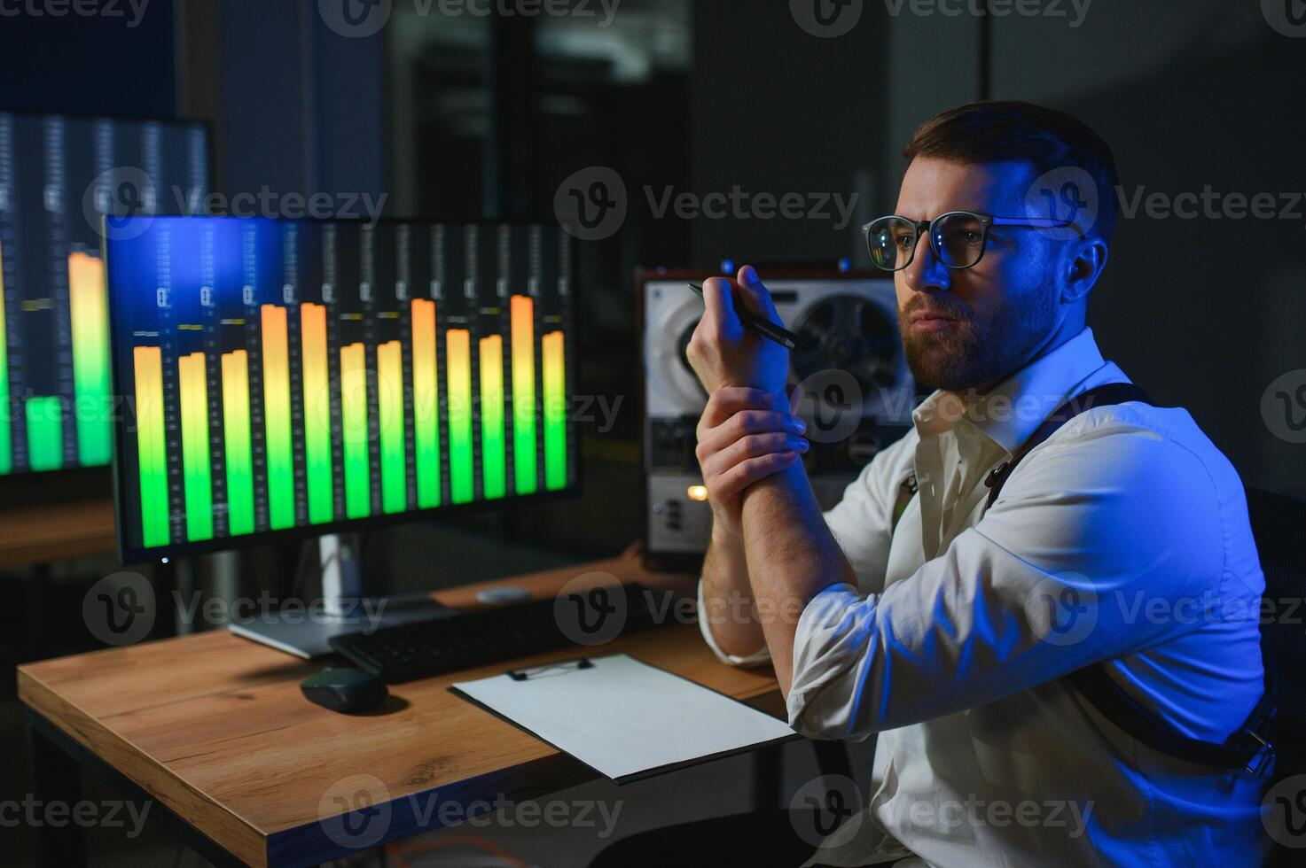 Secret agent listens on the reel tape recorder. Officer wiretapping in headphones photo