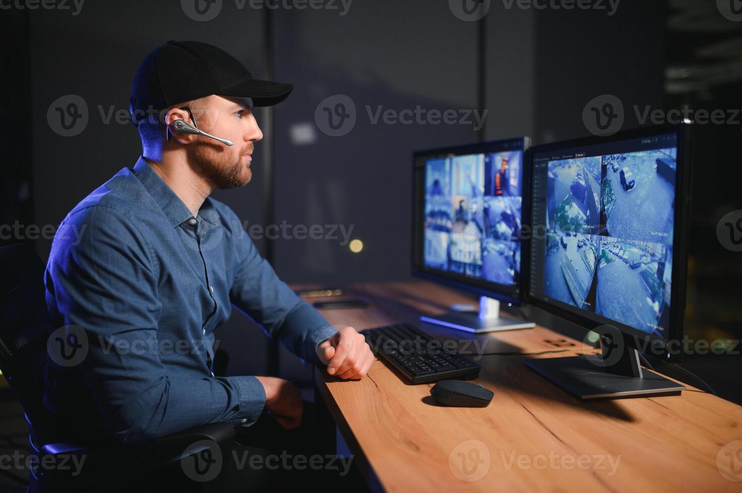 Male security guard in surveillance room photo