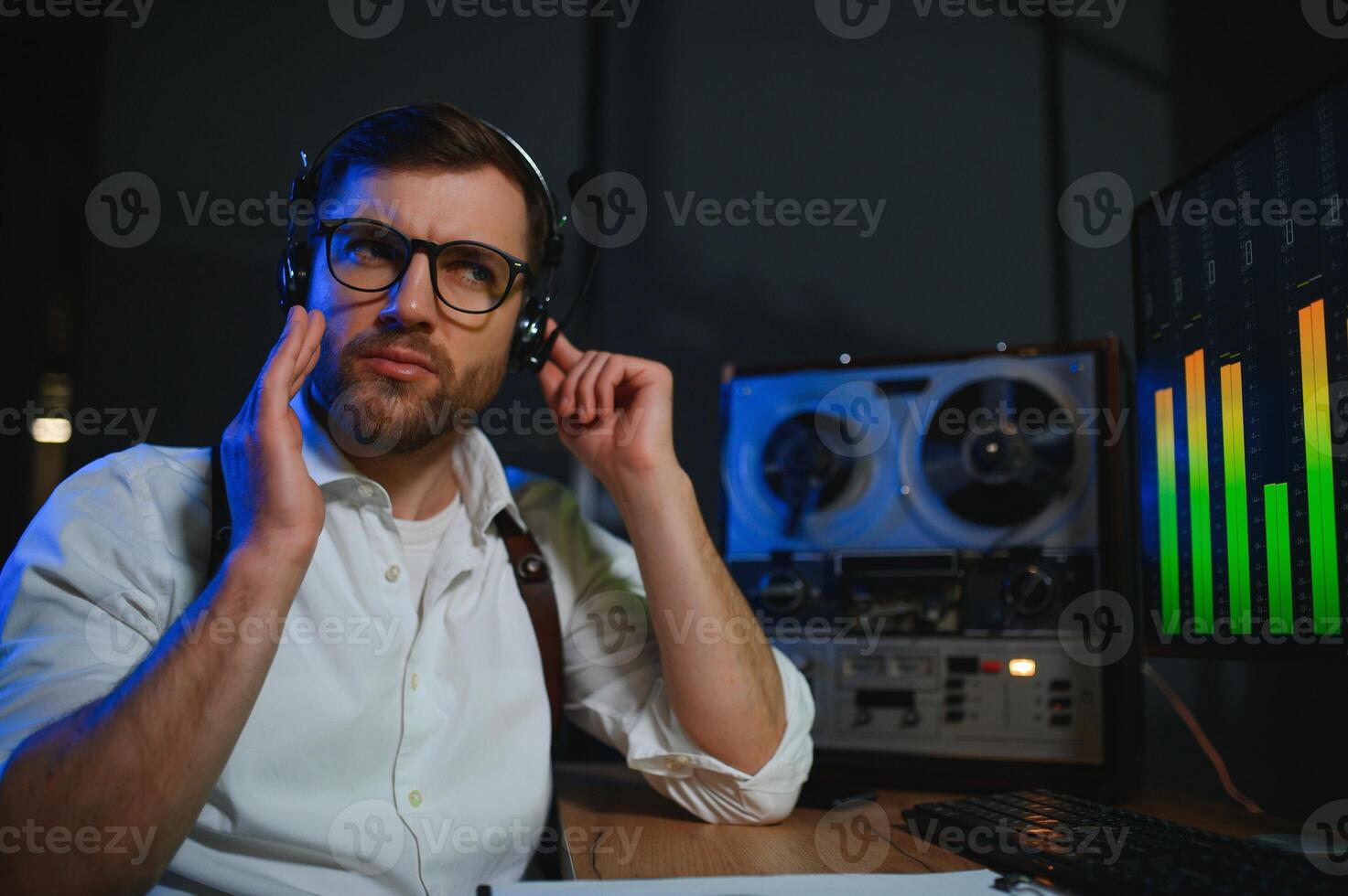 Secret agent listens on the reel tape recorder. Officer wiretapping in headphones photo