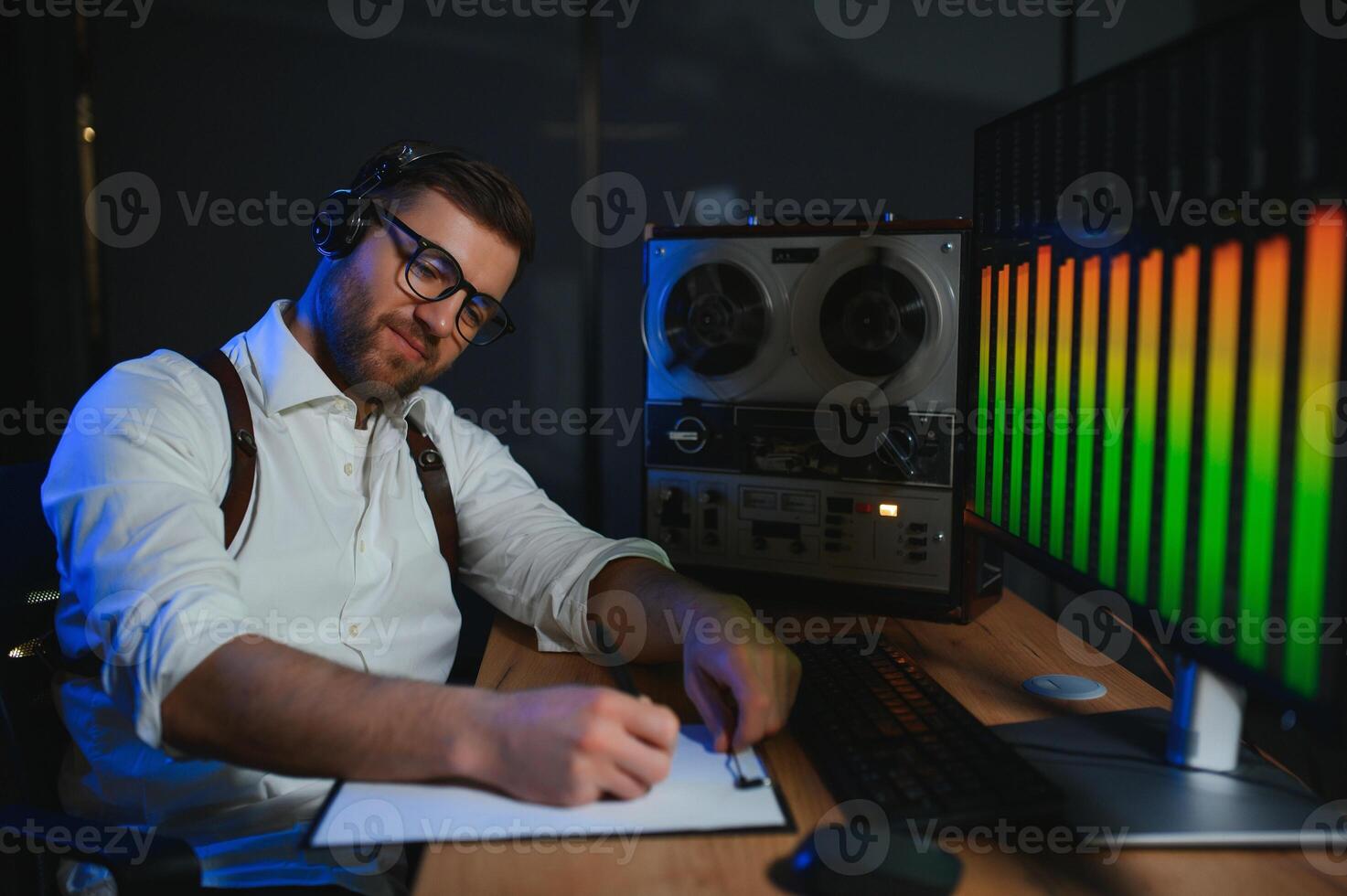 Secret agent listens on the reel tape recorder. Officer wiretapping in headphones photo