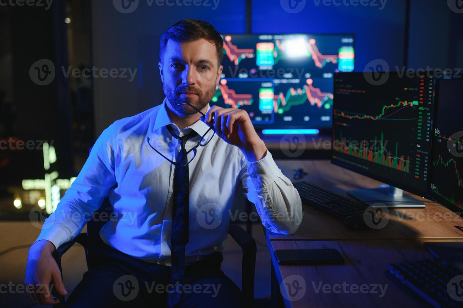 Financial Analyst. Businessman Works in Investment Bank Downtown Office at Night photo