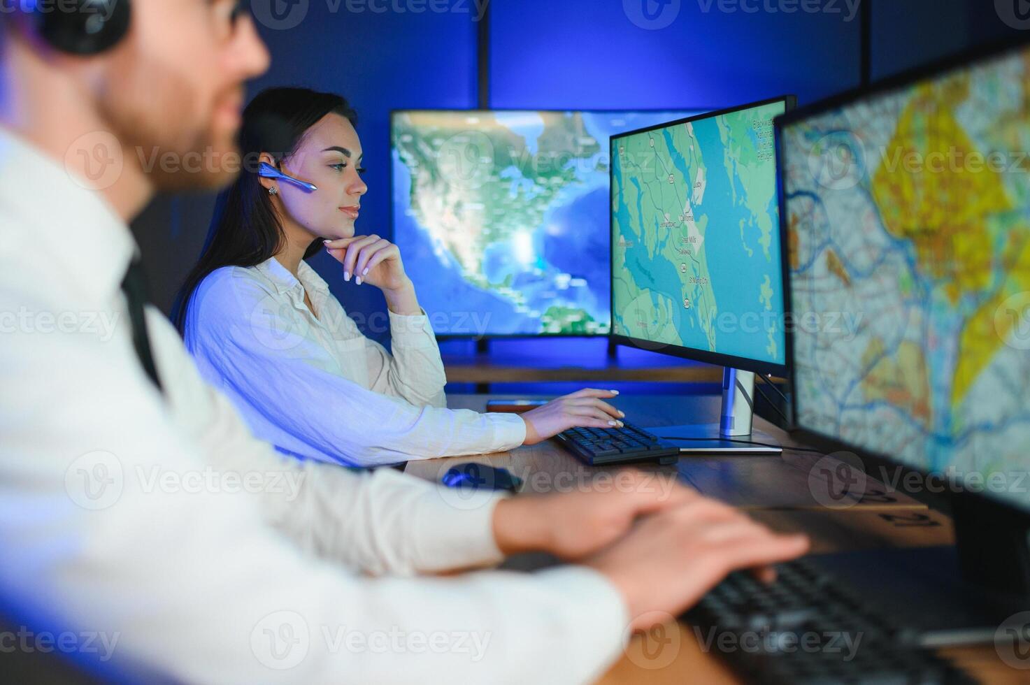 Smiling friendly female call center agent with headset working on support hotline in the office photo