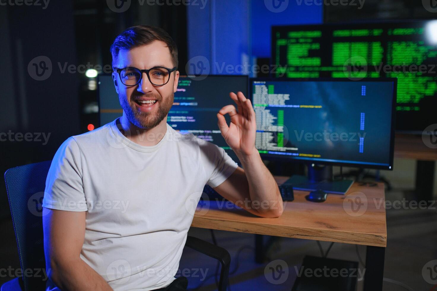 Night Office Young Handsome Man in Working on Desktop Computer. Digital Entrepreneur Typing Code photo