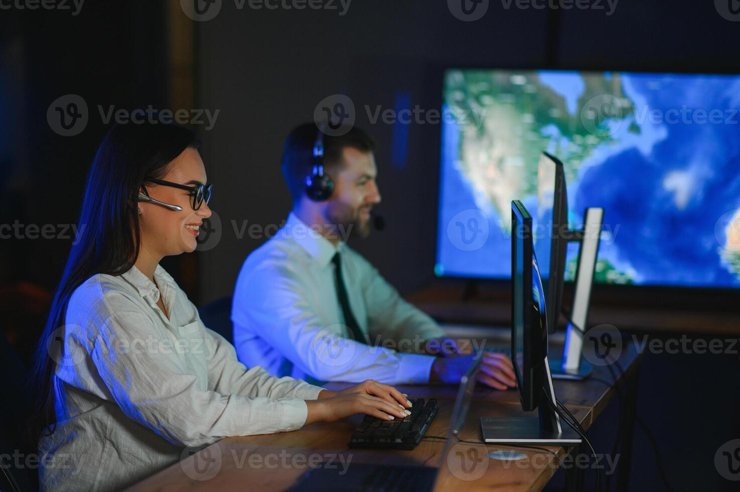 Diverse call center operators team use computers consulting clients in office photo