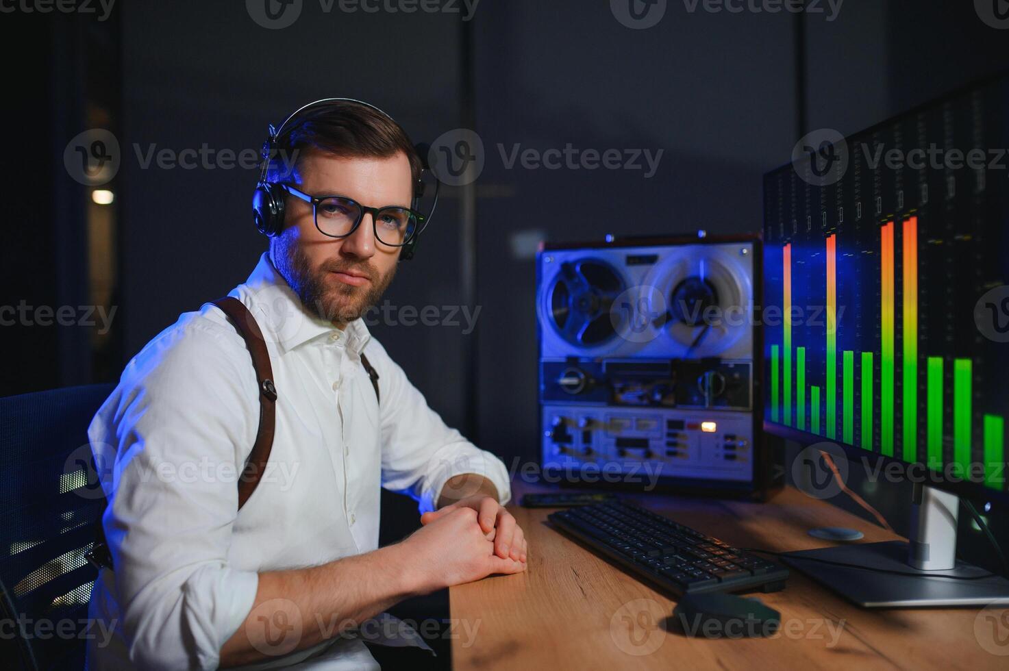 Secret agent listens on the reel tape recorder. Officer wiretapping in headphones. Spying of conversations. Intelligence gathering. Espionage concept photo