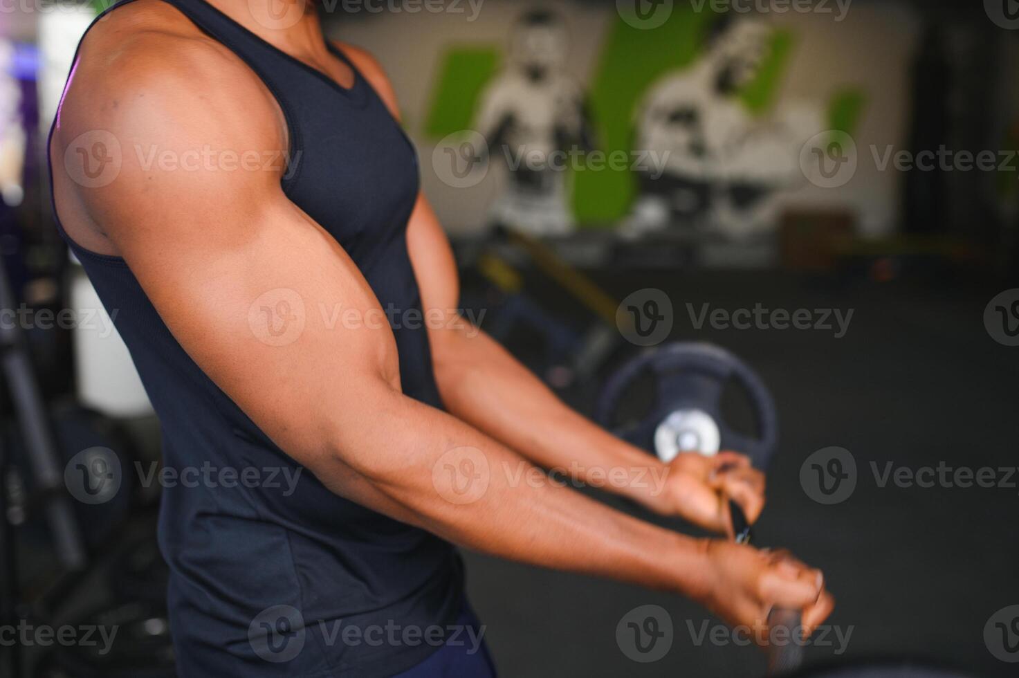 Portrait Of Athletic Man With Barbell In Hands Exercising At Gym photo