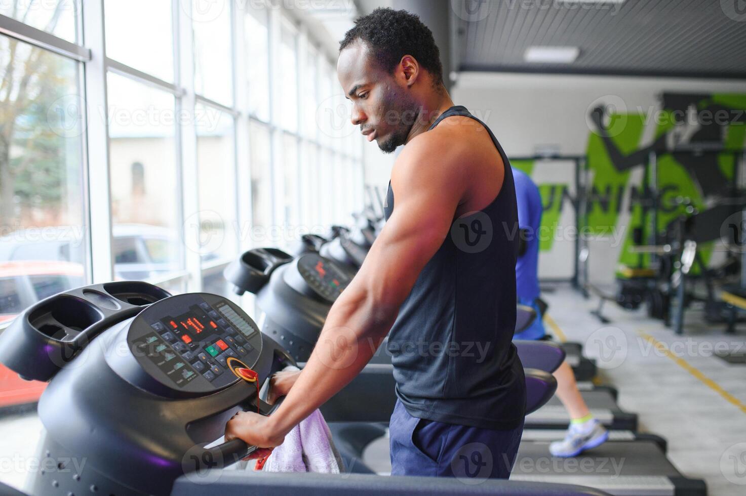 Man running on treadmill in gym photo