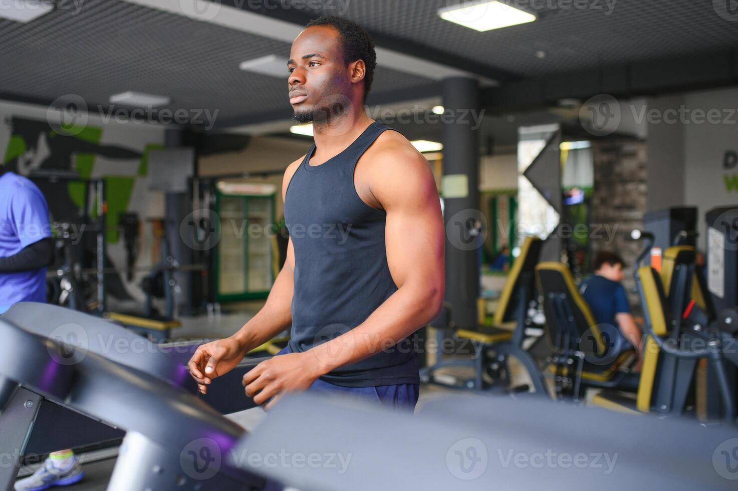 Man running on treadmill in gym photo