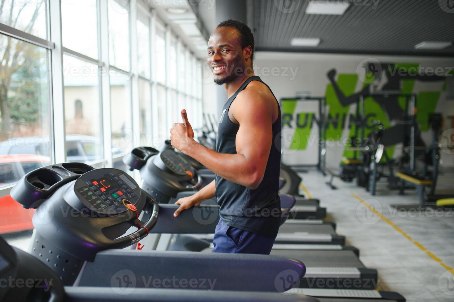Man running on treadmill in gym photo