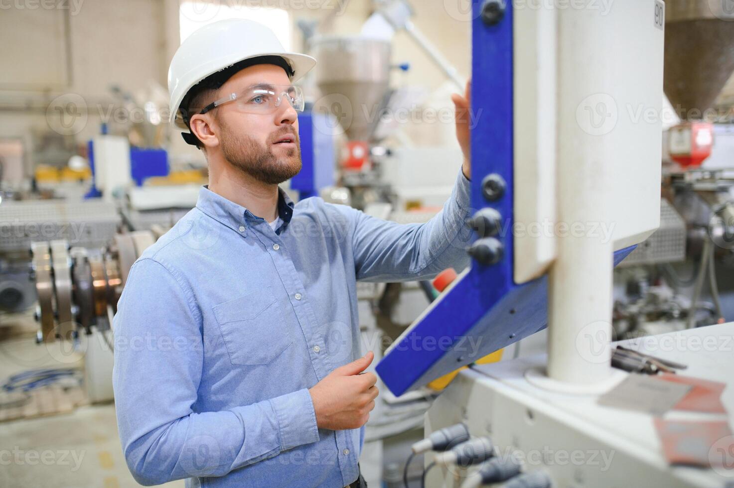 Portrait of confident handsome technical engineer in hardhat. photo