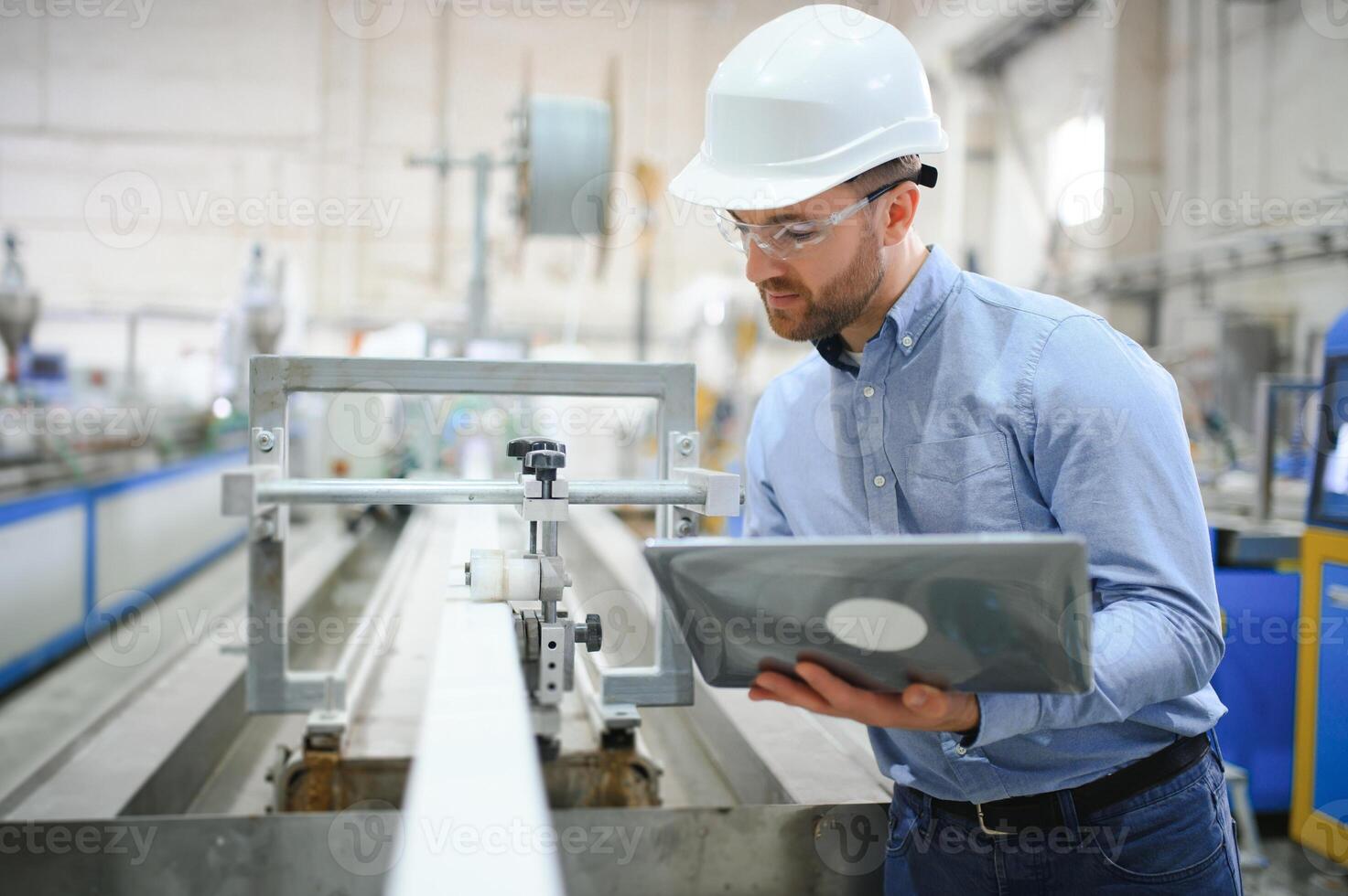 Portrait of confident handsome technical engineer in hardhat. photo