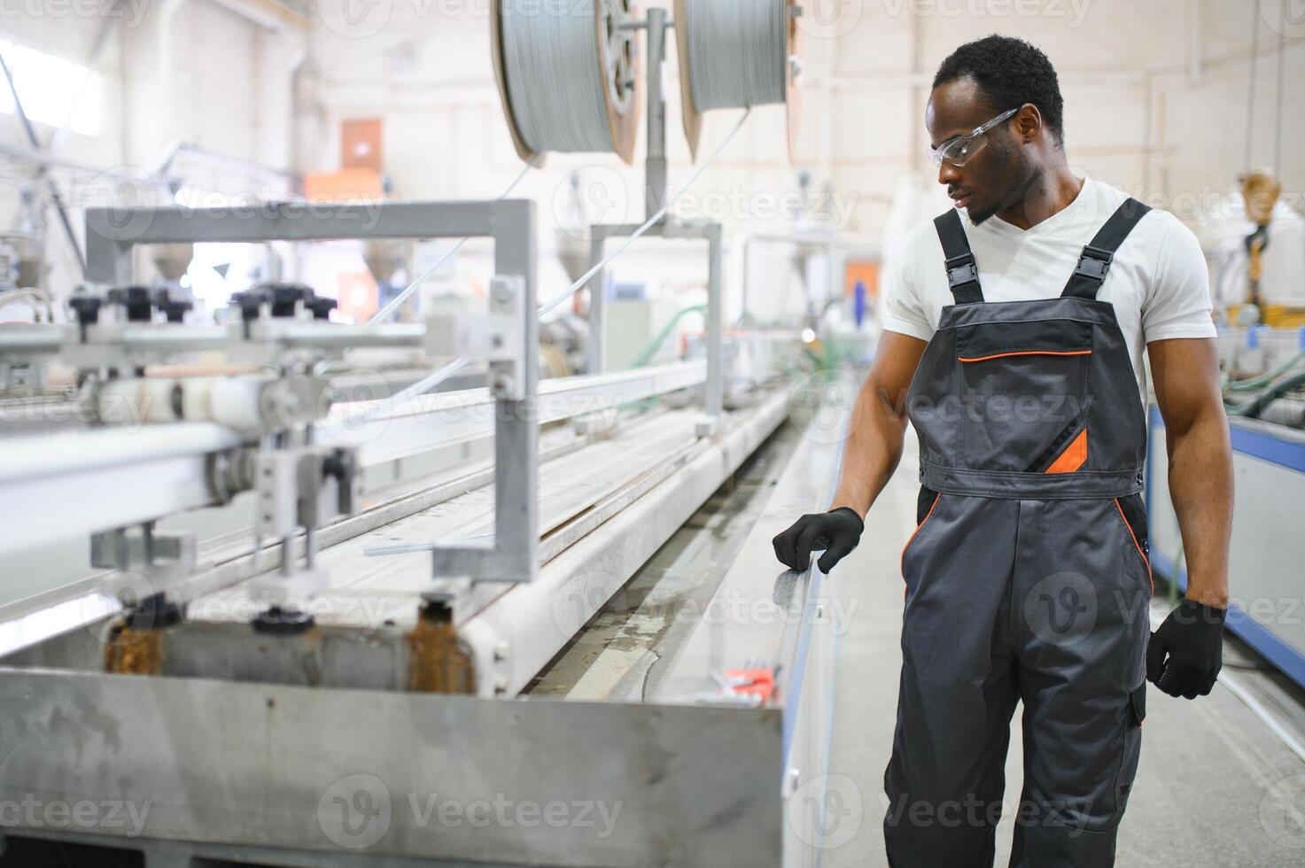 An African-American male worker in a plastic window frame factory photo