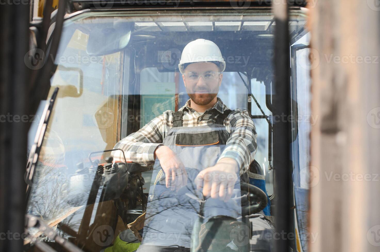 A man on a forklift works in a large warehouse, unloads bags of raw materials photo