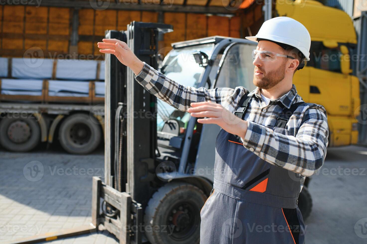 Man worker at forklift driver happy working in industry factory logistic ship photo