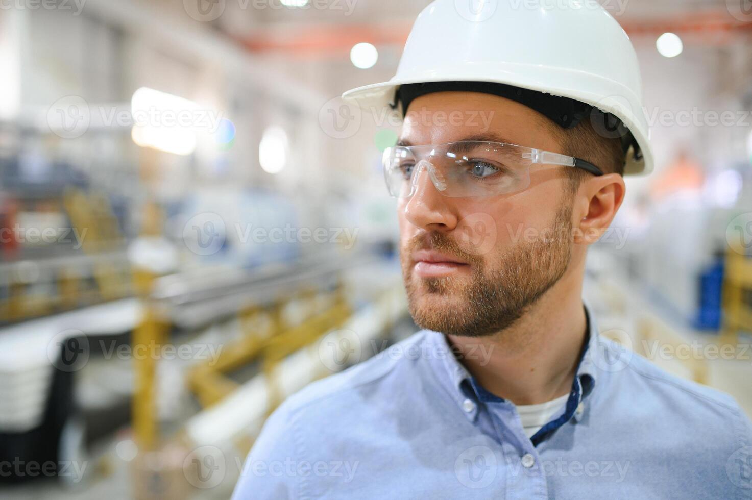 Portrait of confident handsome technical engineer in hardhat. photo