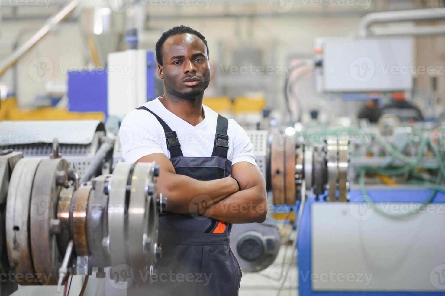 An African-American male worker in a plastic window frame factory photo