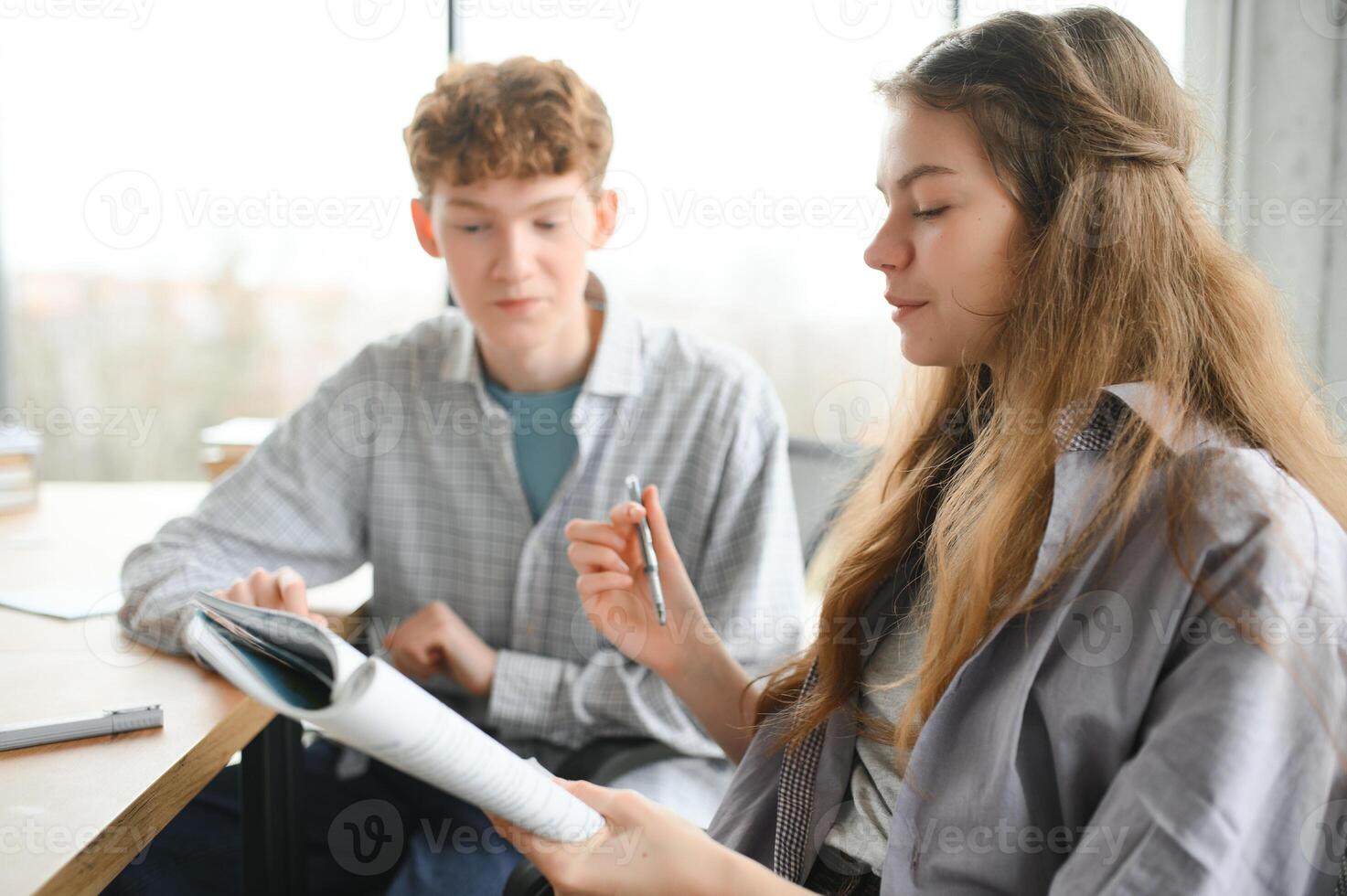 Group of college students doing homework photo