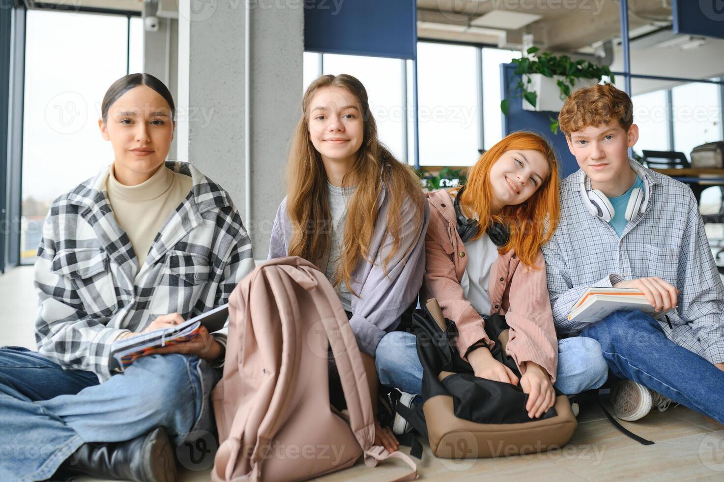 Happy diverse college students posing for group portrait, looking at camera, smiling photo