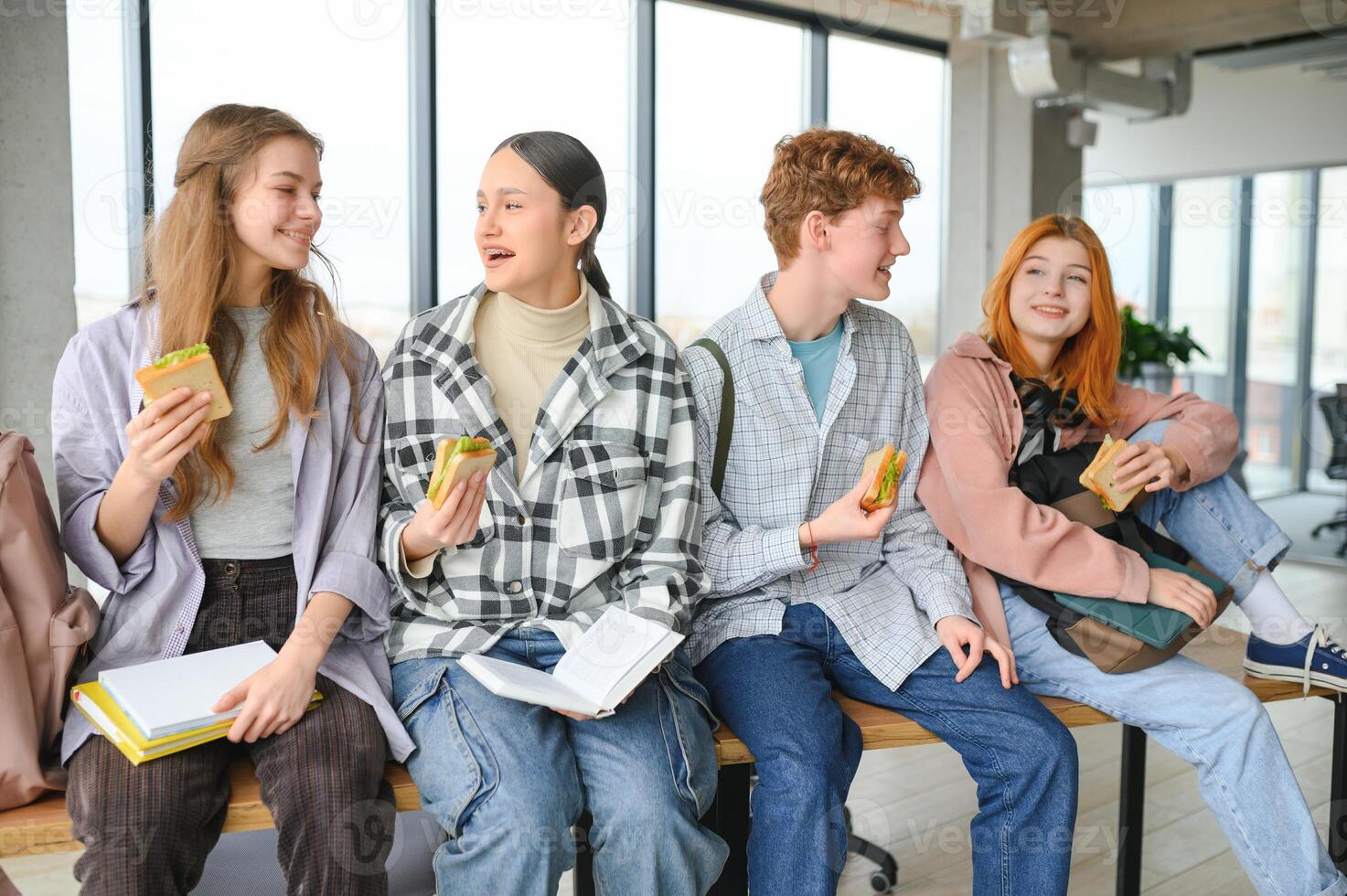 Pupils having lunch in classroom photo