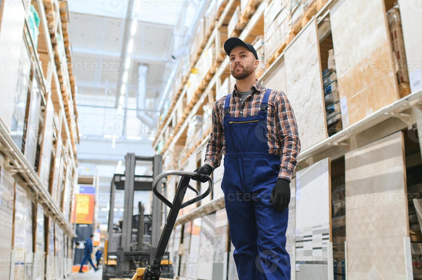 a worker in a hardware store stands in a warehouse photo