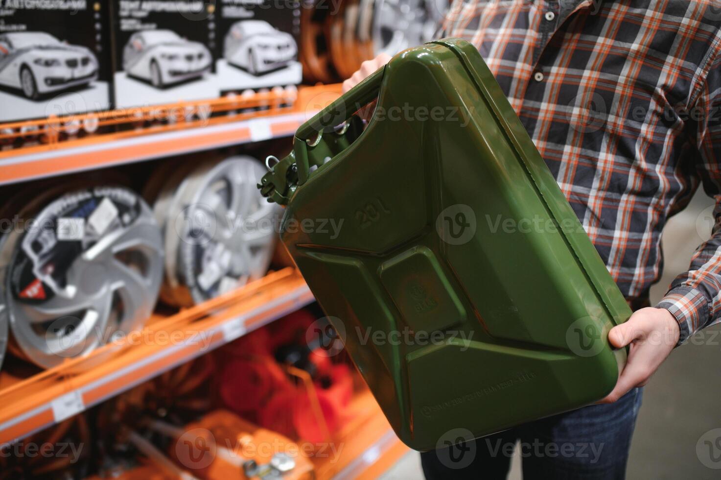 A male customer stands in an auto parts store with a jerry can photo