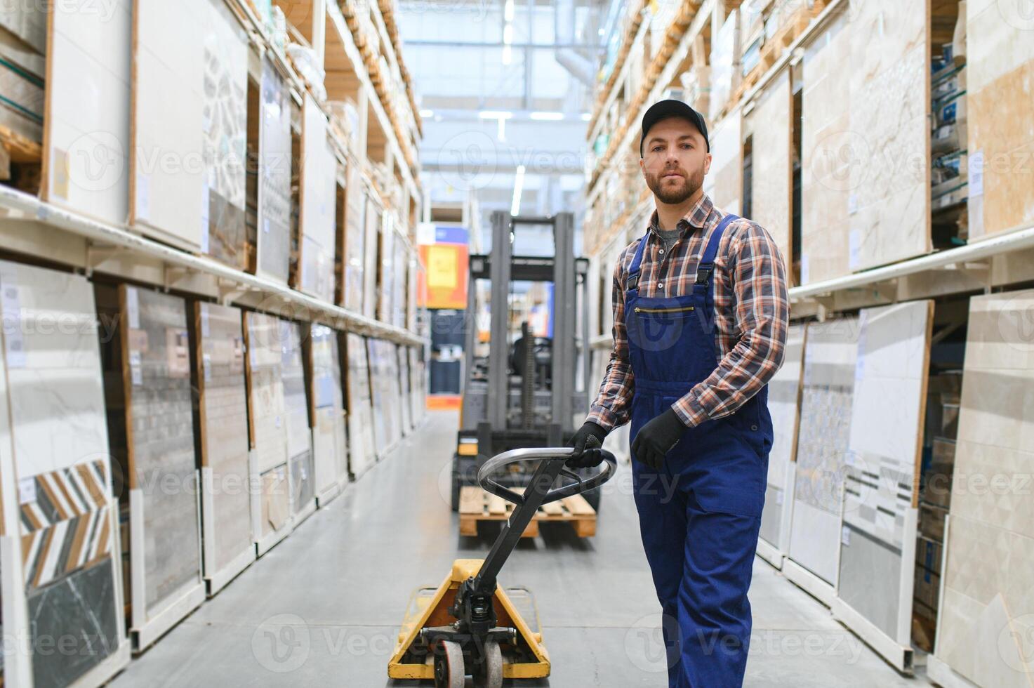 a worker in a hardware store stands in a warehouse photo