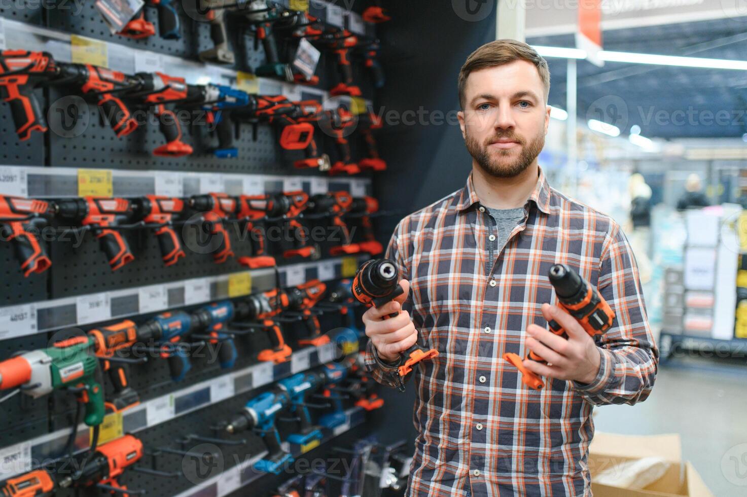 Man shopping for drill in hardware store photo