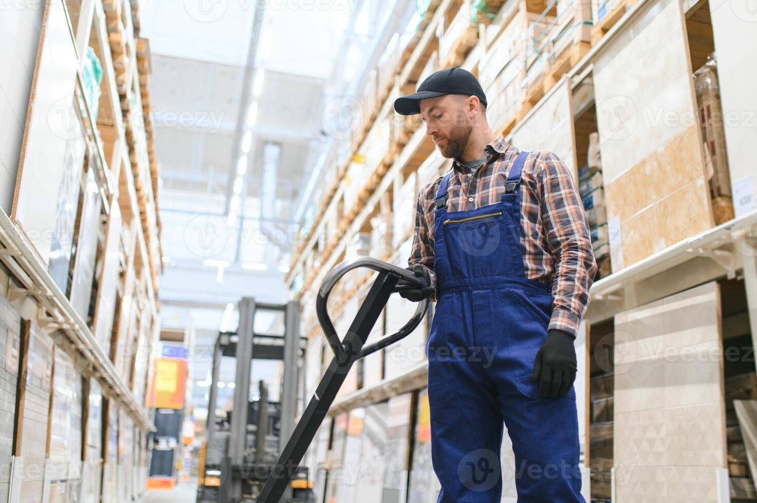 a worker in a hardware store stands in a warehouse photo