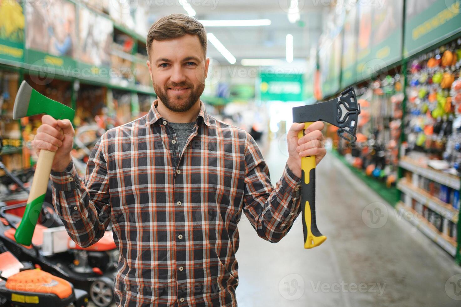 a young man in a gardening equipment store photo