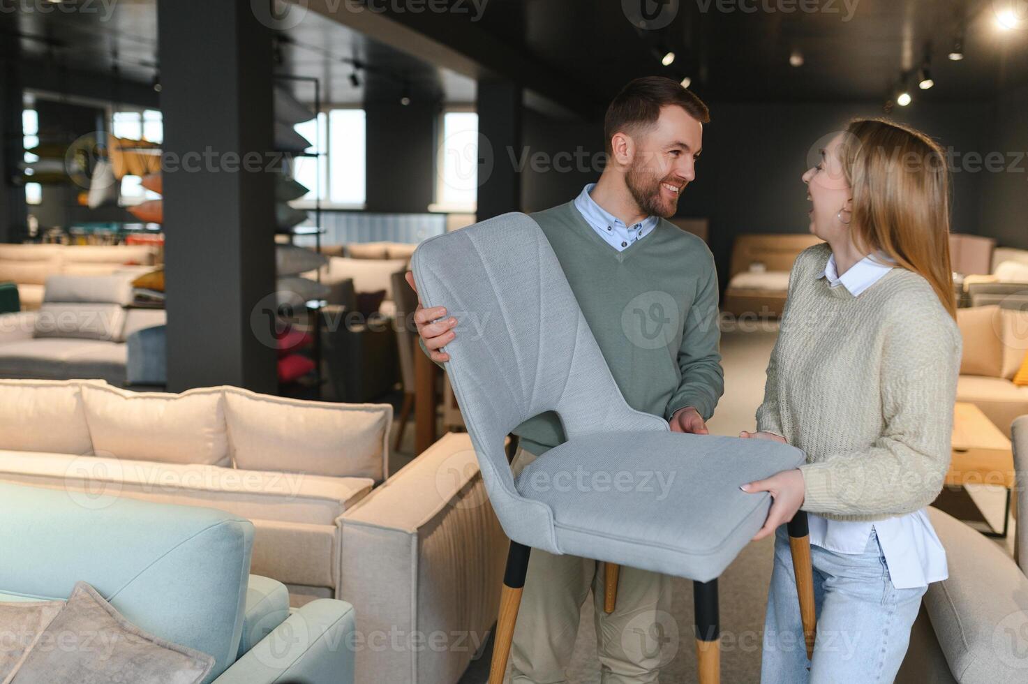 Happy couple choosing furniture in store photo