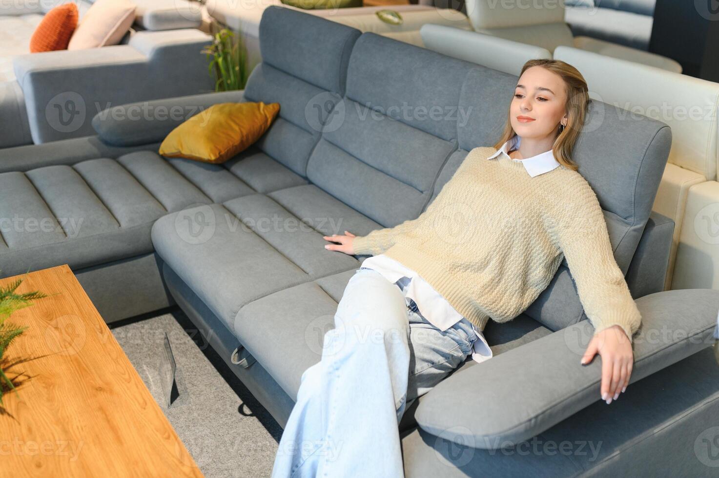 young woman shopping for furniture, sofa and home decor in store photo