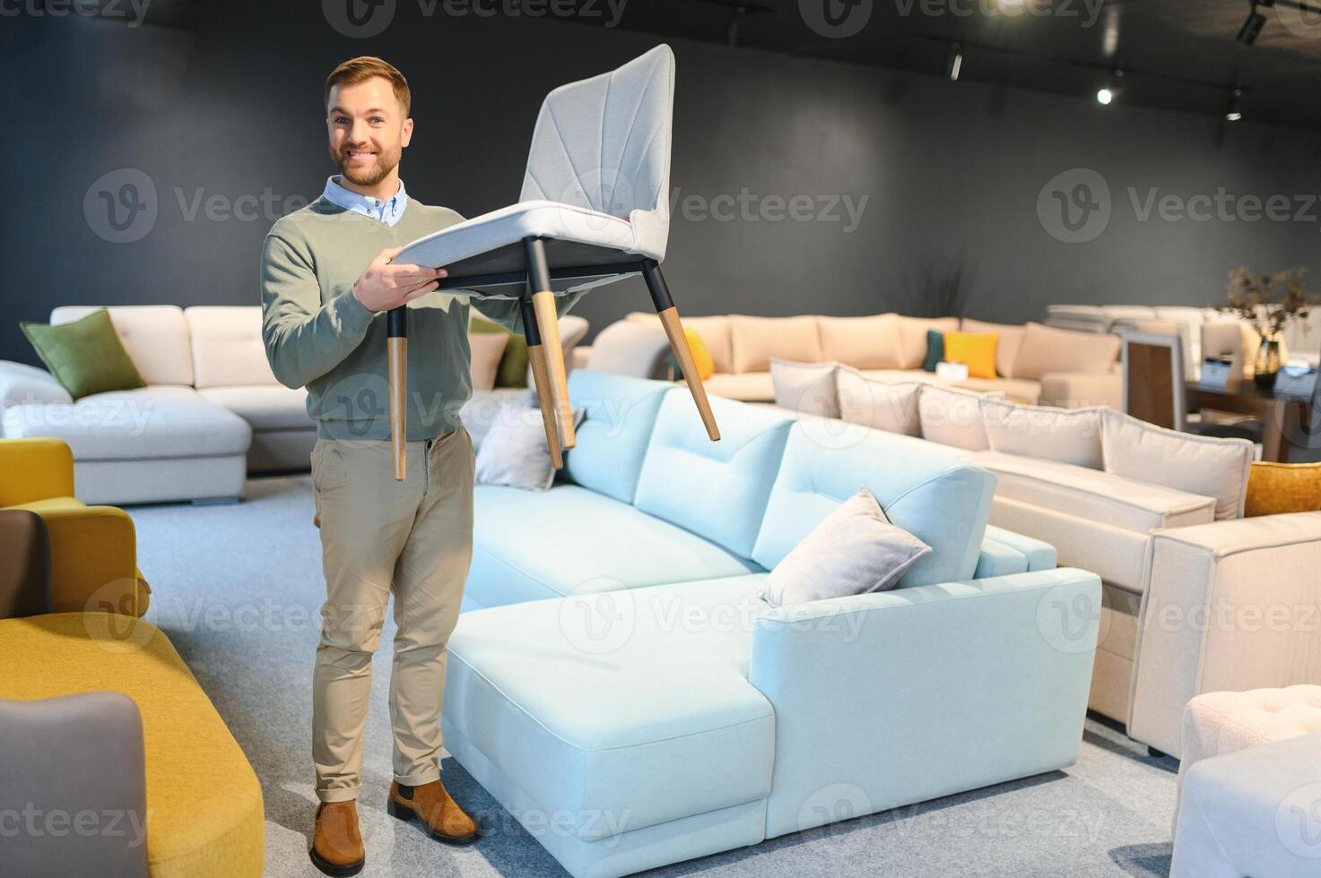 Front view of customer choosing chair in furniture store. photo